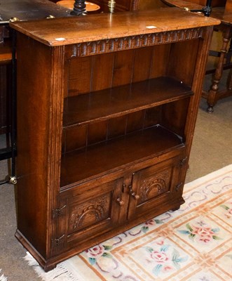 Lot 1284 - A Titchmarsh & Goodwin oak small open bookcase with two lower doors, 87cm by 27cm by 97cm
