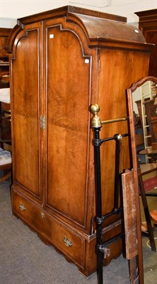 Lot 1289 - A walnut veneered double wardrobe, the base with a single drawer, 110cm by 55cm by 181cm