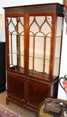 Lot 1309 - A Chippendale style glazed mahogany bookcase decorated with blind fretwork, 106cm by 38cm by 196cm