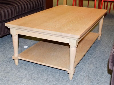 Lot 1318 - A modern ash coffee table fitted with a shelf stretcher 120cm by 65cm by 41cm