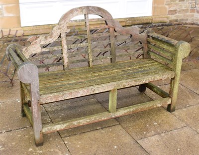 Lot 1334 - A slatted wooden garden bench in the Chinese taste, 167cm long