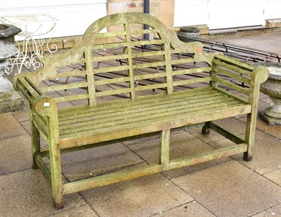 Lot 1335 - A slatted wooden garden bench in the Chinese taste, 167cm long