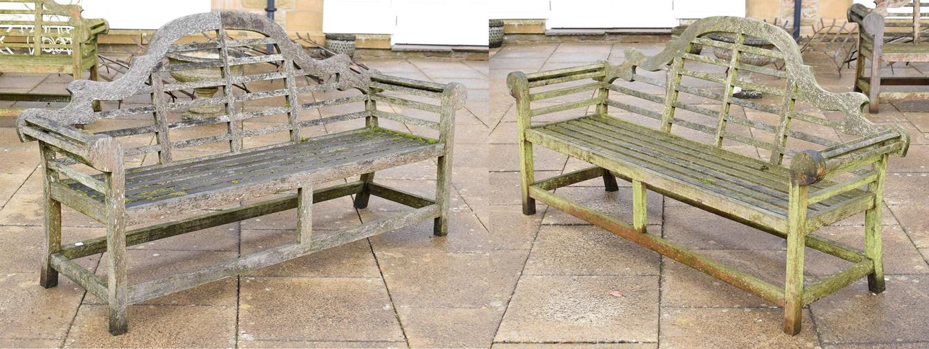 Lot 1339 - A pair of slatted wooden garden benches in the Chinese style, each 194cm long