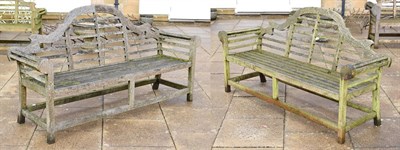 Lot 1339 - A pair of slatted wooden garden benches in the Chinese style, each 194cm long