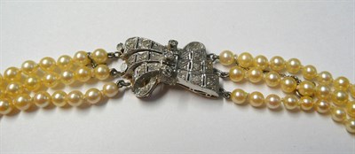 Lot 657 - A Cultured Pearl Necklace, three rows of 95:101:107 knotted graduated cultured pearls strung to...