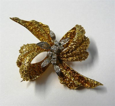 Lot 659 - An 18 Carat Gold Bow Brooch, of textured beaded form in yellow gold, with a central display of...