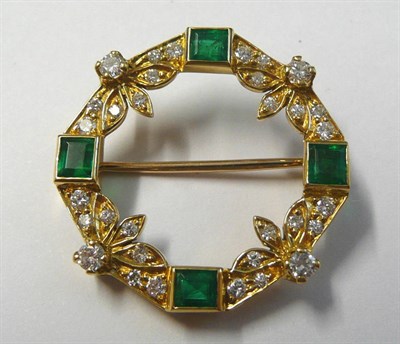 Lot 660 - An 18 Carat Gold Emerald and Diamond Hoop Brooch, four step cut emeralds in yellow collet settings