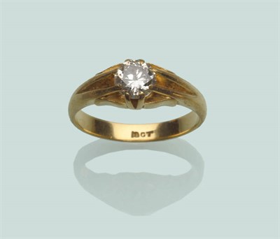 Lot 664 - A Diamond Solitaire Ring, a round brilliant cut diamond, in a yellow claw setting, to a plain...