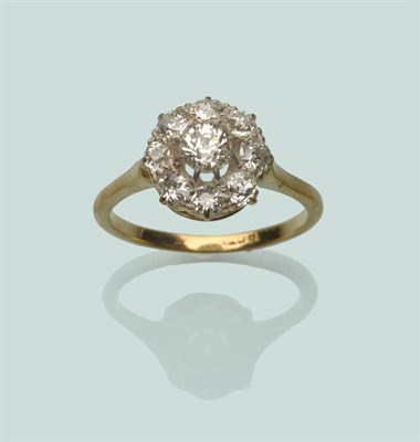 Lot 666 - A Diamond Cluster Ring, an old cut diamond in a protruding white claw setting within a border...