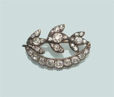 Lot 667 - A Diamond Brooch, old cut diamonds arranged as three flowers, over a crescent, in white claw...