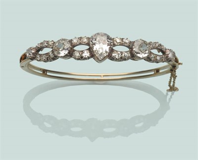 Lot 669 - A Victorian Diamond Bangle, an old pear cut diamond with an old cut diamond either side,...