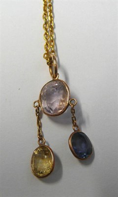 Lot 675 - A Gemstone Pendant, an oval cut rose quartz suspends a chain linked yellow sapphire, and a blue...