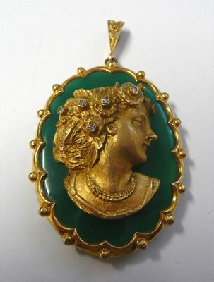 Lot 679 - A 9 Carat Gold Mounted Pendant, an oval green stone in a scalloped edge and beaded border...