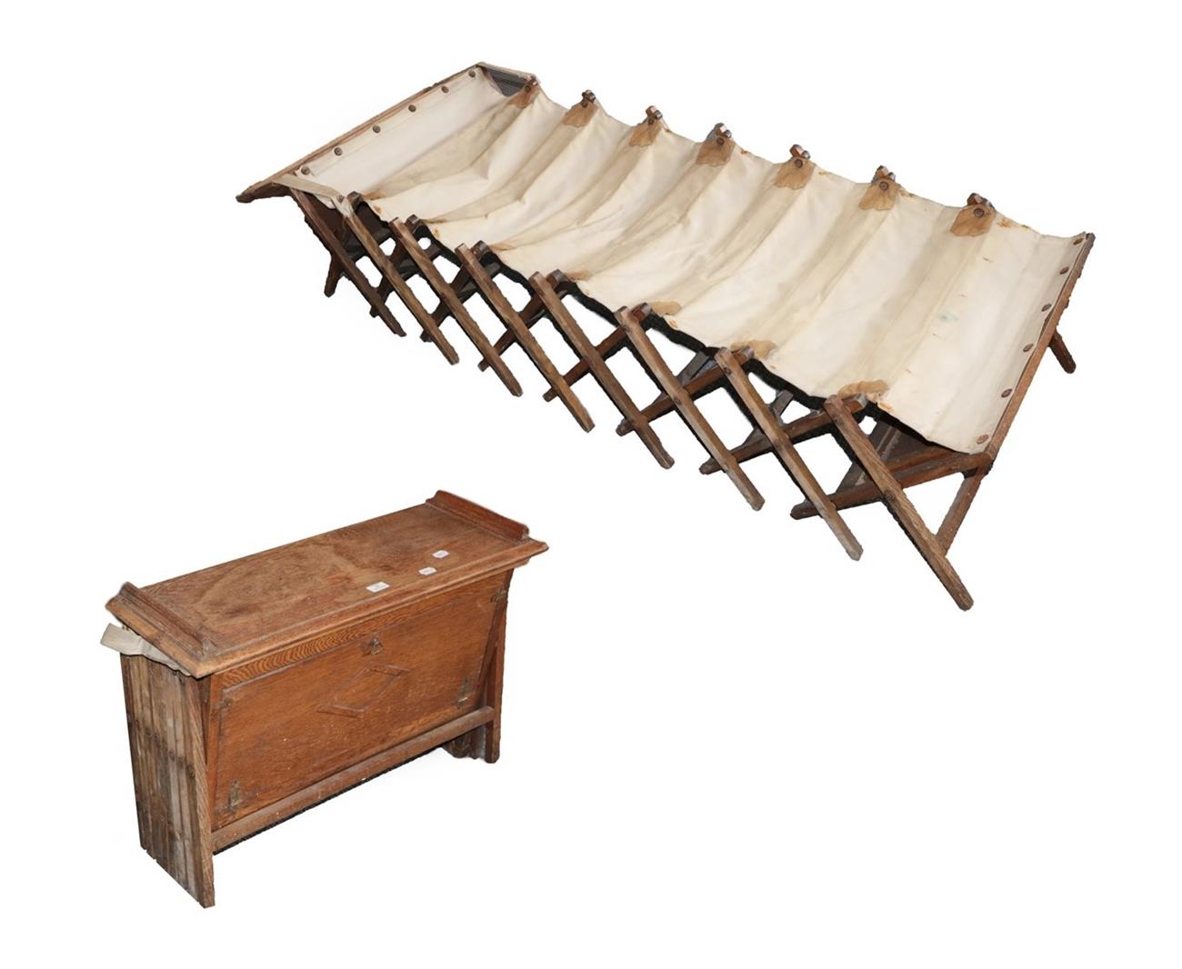Lot 62 - An Early 20th Century Oak Campaign Bed, with a hinged rectangular top rising to form the...