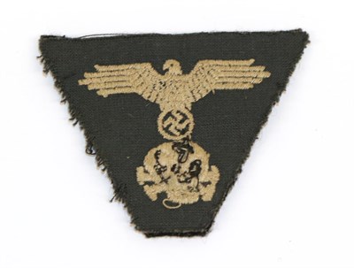 Lot 101 - A German Third Reich Waffen SS Trapezoid Cap Insignia, the black wool field with cotton backing...