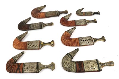 Lot 143 - A Collection of Eight Arab Jambiyas, 20th century, each with curved blade with raised medial ridge