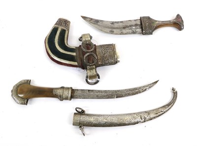 Lot 144 - An Early 20th Century Moroccan Jambiya, with 21cm double edge curved steel blade, rhinoceros...