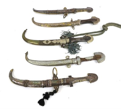 Lot 148 - Five 20th Century Moroccan Arab Jambiyas, two with silver and brass mounts to the hilts and...