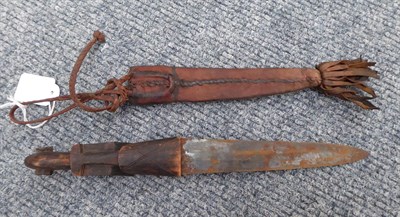 Lot 150 - A Masai Seme Knife, with 26cm double edge leaf shape blade, hide bound grip and scabbard; two...