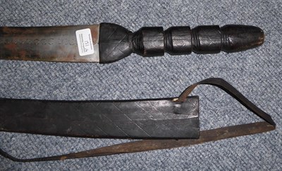 Lot 151 - A Tuareg Type Sword, with diaper engraved steel blade, leather bound grip and scabbard; two...