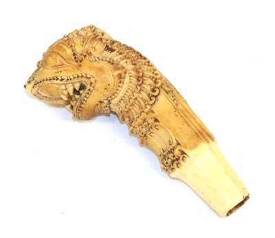 Lot 163 - A 17th/18th Century Indian Ivory Dagger Hilt, richly carved as the head of a Yali (mythical...
