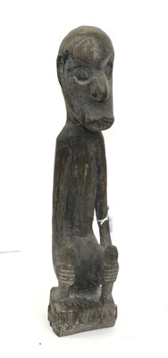 Lot 186 - A 20th Century Dyak Ironwood Ancestor Figure, Borneo, squatting with elongated body and arms,...