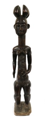 Lot 194 - A 20th Century Attye Large Carved Wood Figure of a Woman, Ivory Coast, standing with four...