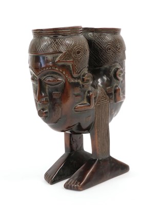 Lot 195 - A 20th Century Kuba Janus Head Palm Wine Cup, each head with incised diaper coiffure, shaped...