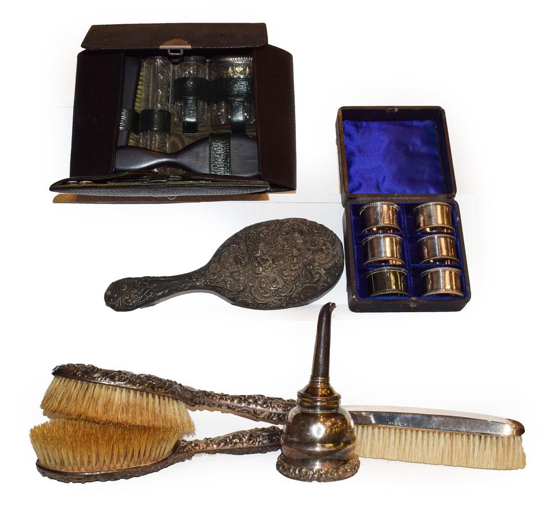 Lot 27 - Four various silver backed dressing table items, a gent's leather travelling vanity case containing
