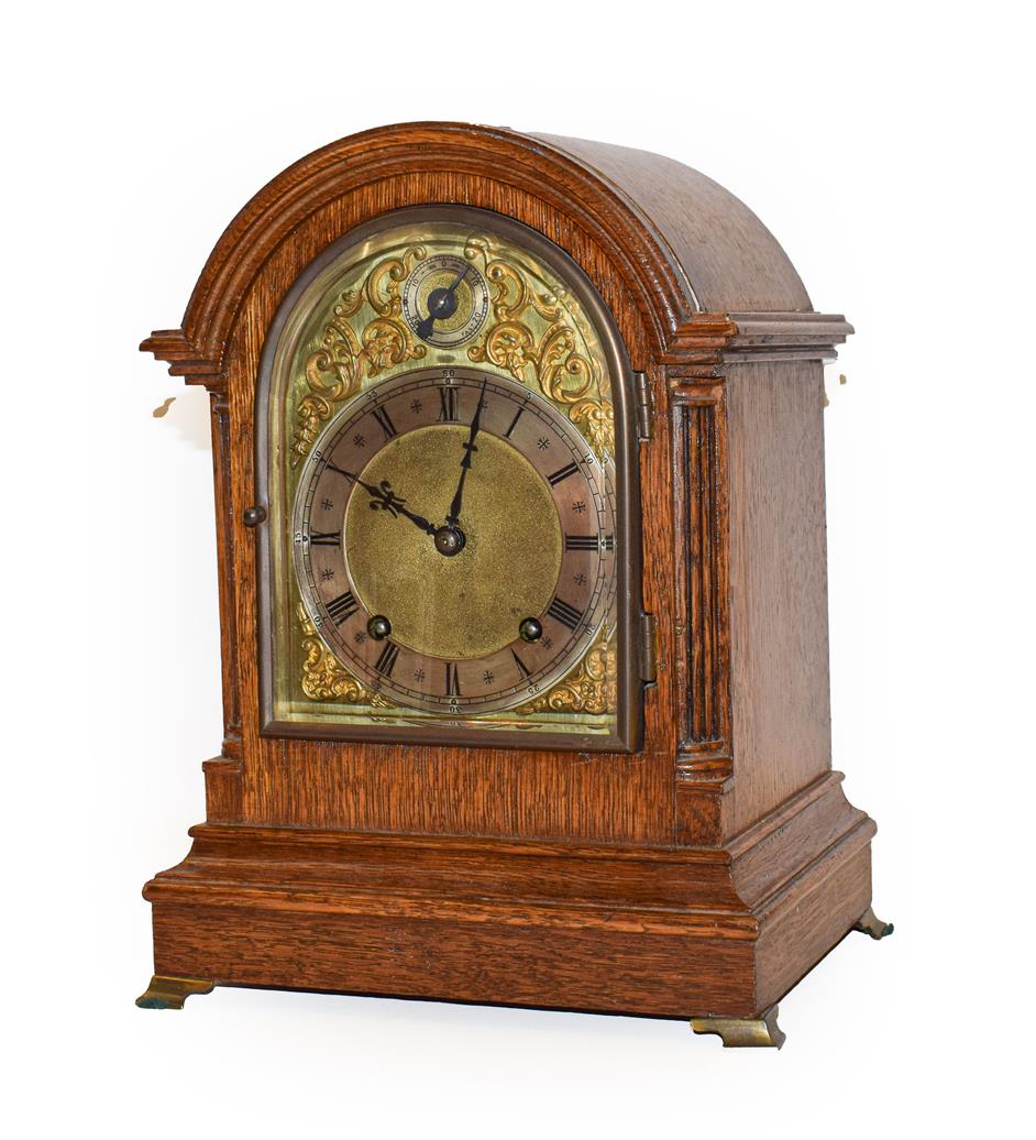 Lot 50 - An oak striking mantel clock, early 20th century, movement backplate stamped W & H Sch, striking on