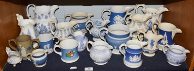 Lot 79 - A group of early 19th century English sprigged pottery jugs of varying designs and size...