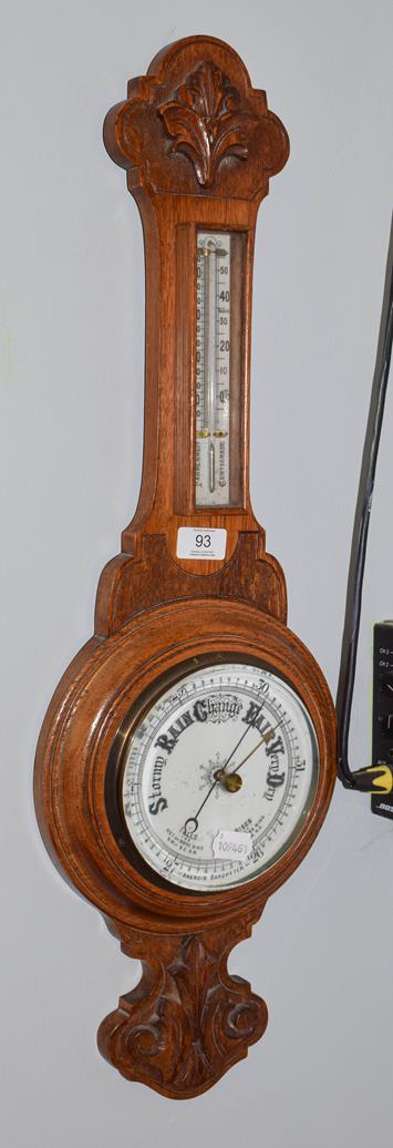 Lot 93 - An oak cased aneroid barometer