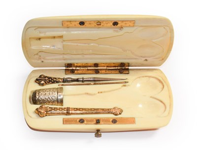 Lot 114 - A 19th century French ivory necessaire engraved with a monogram containing silver and silver...