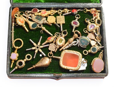 Lot 146 - A collection of 19th/20th century pocket watch keys including a paste set example, agate set,...