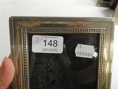 Lot 148 - A sliver photograph frame, Sheffield 2001, 17cm by 22cm together with a pair of matching...