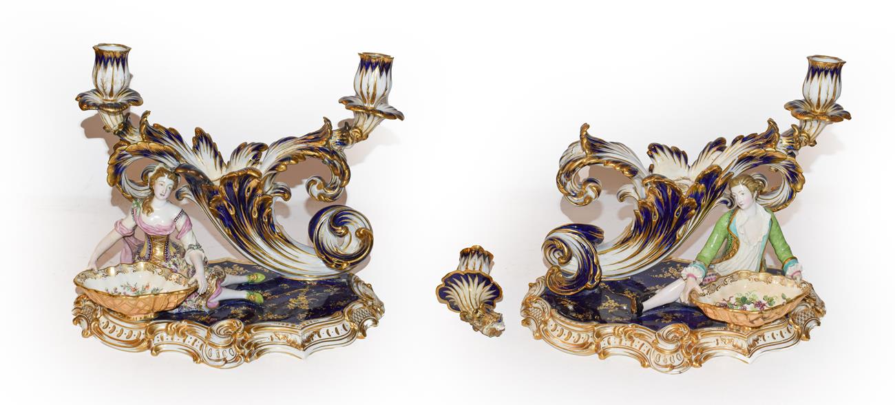 Lot 149 - A pair of 19th century English porcelain twin-sconce candle holders modelled with a lady and...