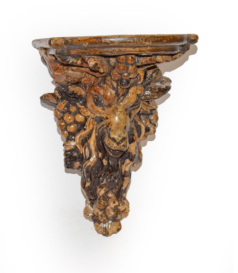 Lot 196 - A 19th century Victorian plaster cast wall bracket shaped as a rams head and glazed