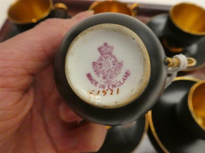 Lot 204 - A set of six Royal Worcester coffee cups and saucers in an unusual matte black finish with...