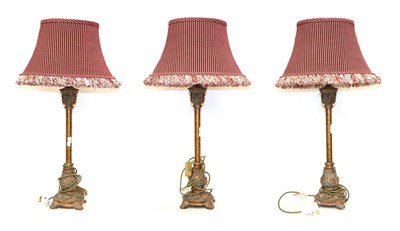Lot 228 - A set of three modern metal effect table lamps, each 54cm high, with red stripe fabric shades (3)