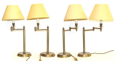Lot 229 - A set of four brushed metal adjustable table lamps with shades, total height 65cm