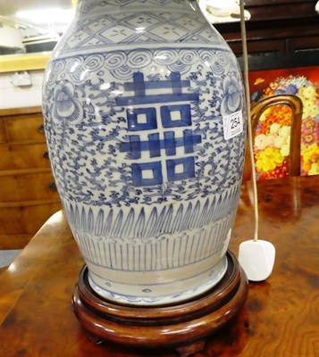 Lot 254 - A pair of Chinese blue and white baluster shaped vases, painted with lotus scrolls and shou...