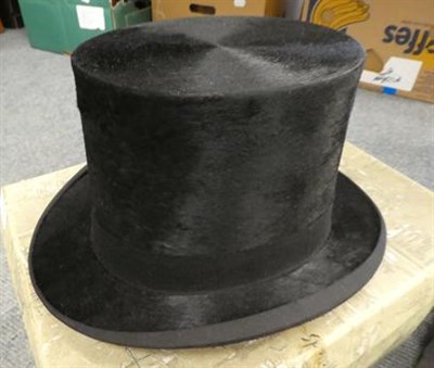 Lot 259 - A Harrods of London grey top hat, 15.5cm by 19.5cm internal measurements, together with a Dunn...