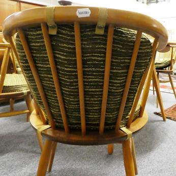 Lot 1054 - A light elm Ercol drop leaf table 123cm by 114cm by 72cm together with four matching horseshoe back
