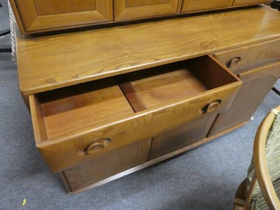 Lot 1055 - A Ercol light elm sideboard 136cms by 47cms by 125cms