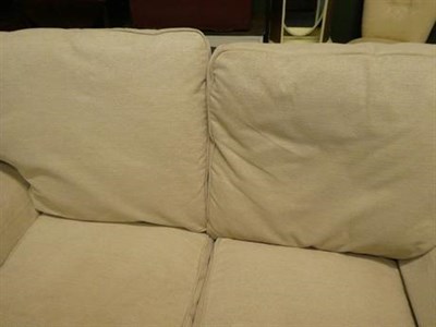 Lot 1063 - A Laura Ashley three seater sofa in cream fabric 180cm long, together with a matching two...