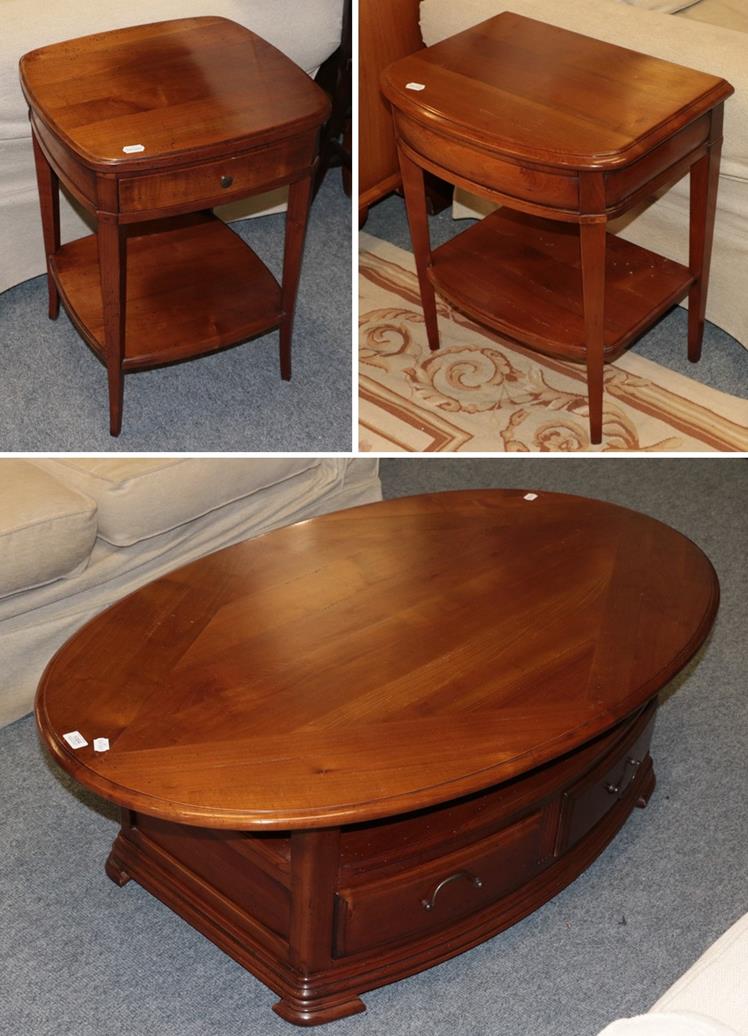 Lot 1064 - A modern yew wood coffee table 130cm by 80cm by 45cm, together with two similar bedside tables both