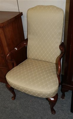 Lot 1069 - A mahogany framed open armchair with out swept down scrolled arms on scroll carved legs and pad...