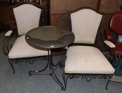 Lot 1074 - A pair of modern metal framed garden armchairs, together with a matching table