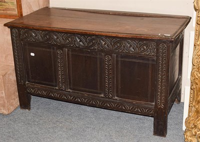 Lot 1095 - An 18th century carved oak coffer, 124cm by 56cm by 72cm