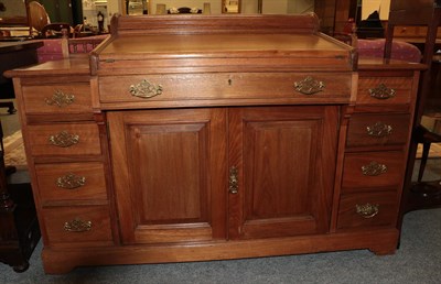Lot 1109 - An early 20th century oak desk of small proportions, the central drawer with Hobbs &Co London...